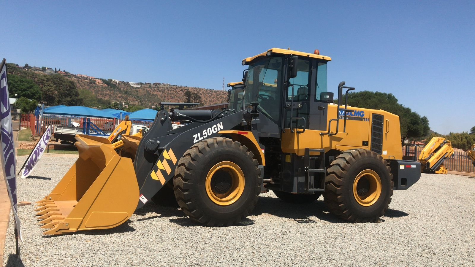 Yellow wheel loader at a dealership yard