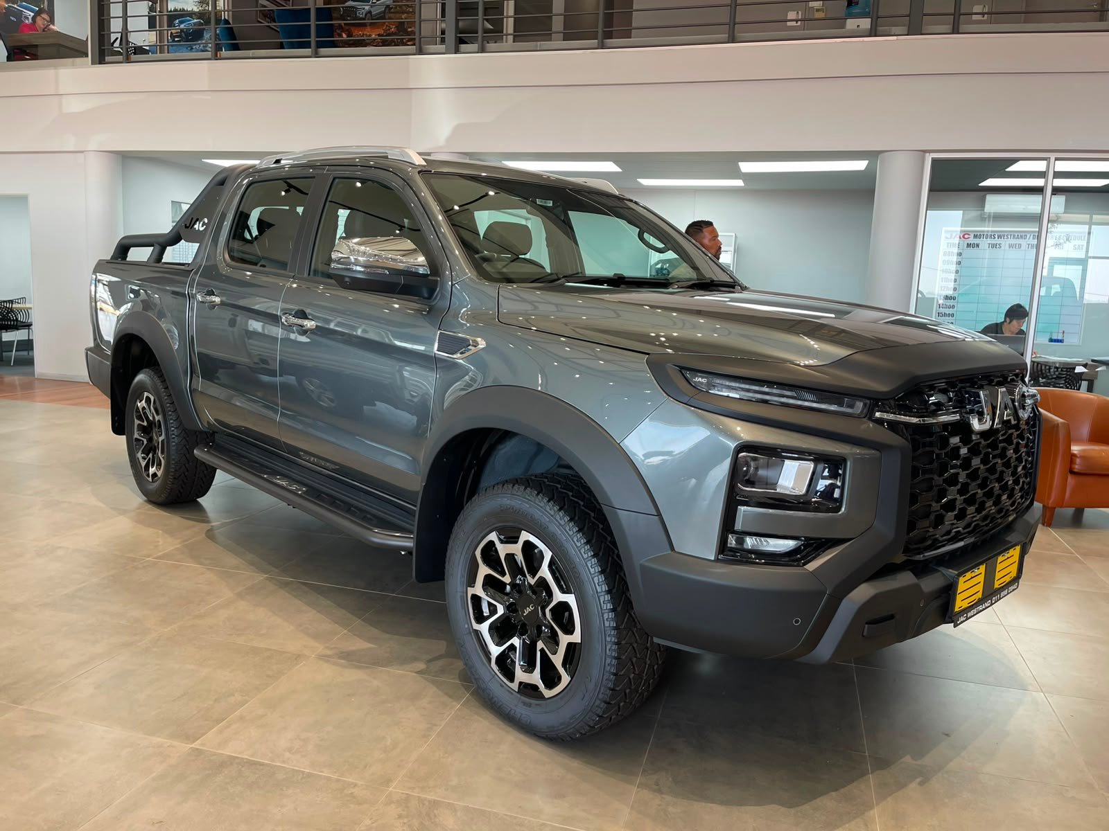 Grey double-cab bakkie inside a dealership showroom