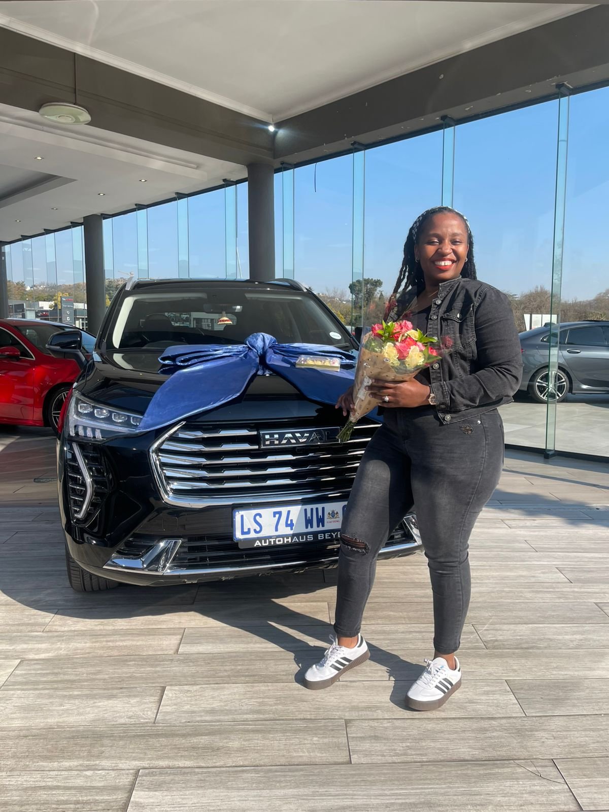 Client standing beside a delivered vehicle